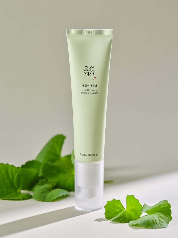 Beauty of Joseon Light On Serum: Centella + Vita C in a green tube with leafy background.