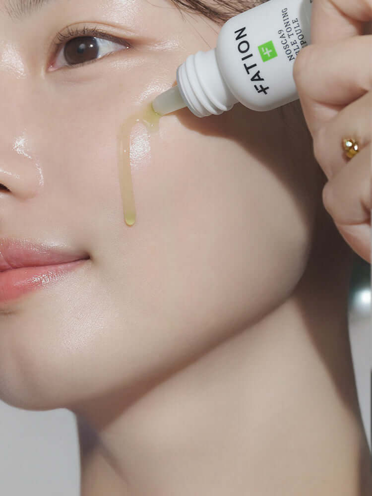 FATION Nosca9 Trouble Toning Ampoule 15ml being applied to a model's skin for refreshed appearance.