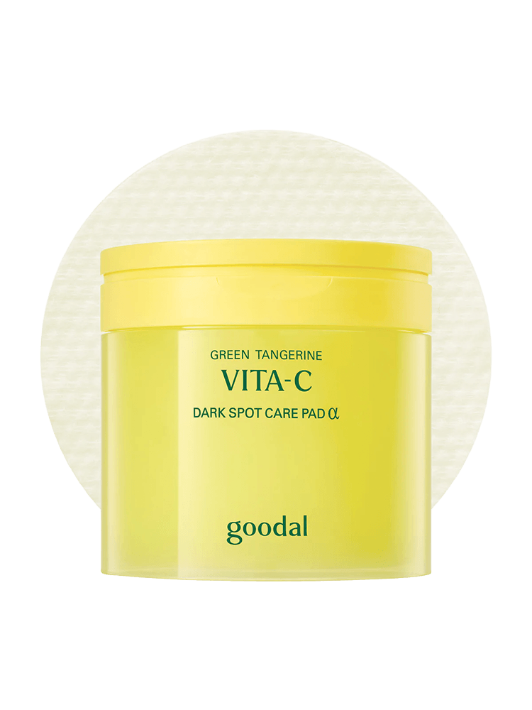 GOODAL Green Tangerine Vita C Dark Spot Care Pad in a bright yellow container on a textured background.