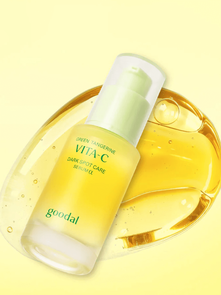GOODAL Green Tangerine Vita C Dark Spot Care Serum Alpha in a glass bottle with yellow serum on a soft background.