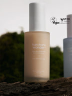 HARUHARU WONDER Black Rice Hyaluronic Anti-wrinkle Serum 50ml in a serene outdoor setting, showcasing its vegan certification.