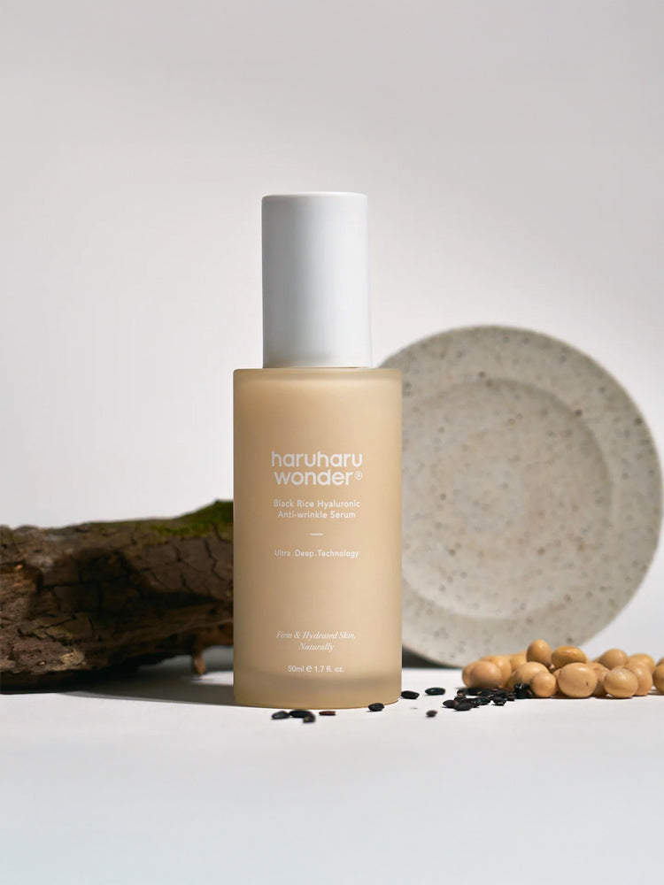 HARUHARU WONDER Black Rice Hyaluronic Anti-wrinkle Serum 50ml in a bottle with a wooden background and a clay plate.