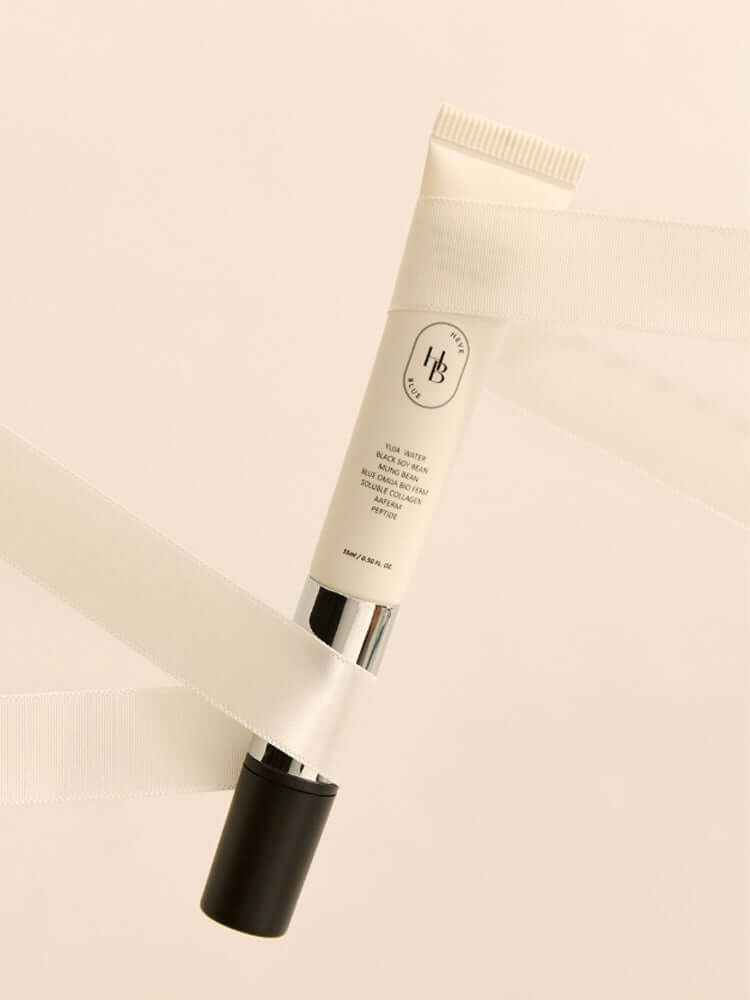 HEVEBLUE Black Yuja Bean Lifting Auto Eye Cream 15ml displayed on a soft background with satin ribbons.