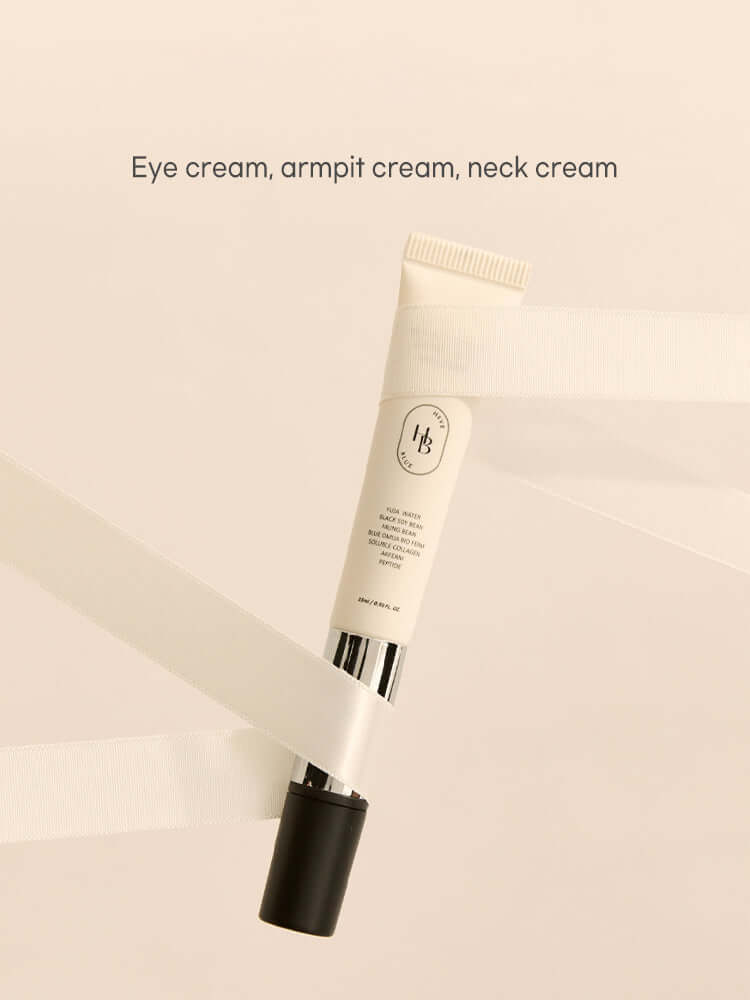 HEVEBLUE Black Yuja Bean Lifting Auto Eye Cream 15ml displayed with ribbons on a soft background.