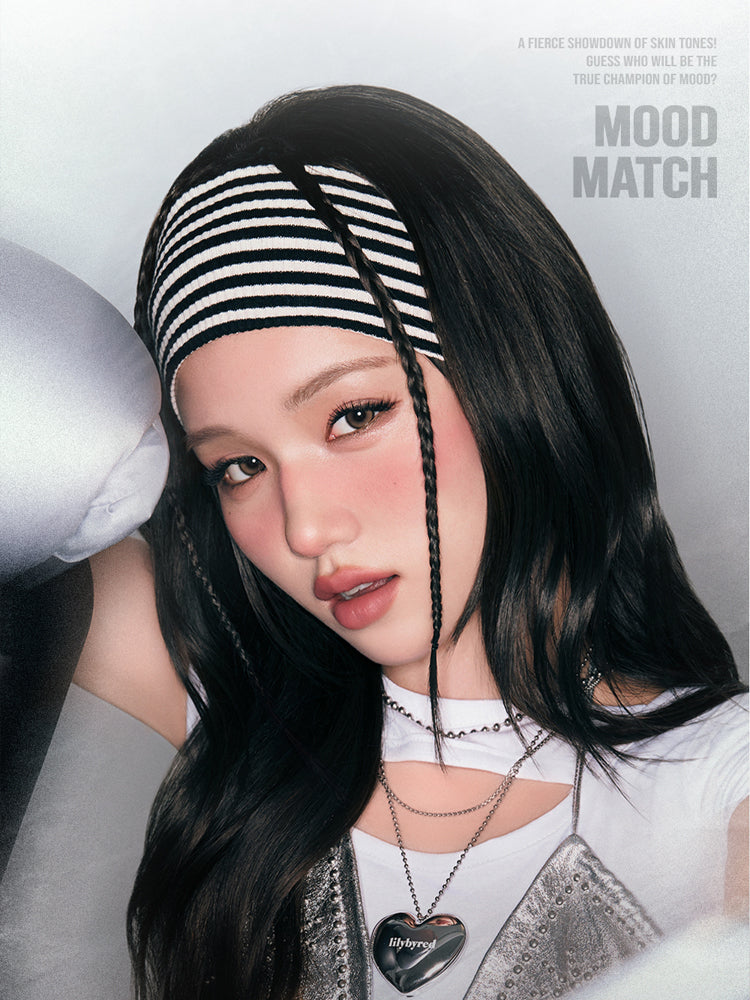 LILYBYRED Luv Beam Cheek Mousse 3.8g, soft mousse blush applied for a rosy glow, featuring a model with stylish accessories.