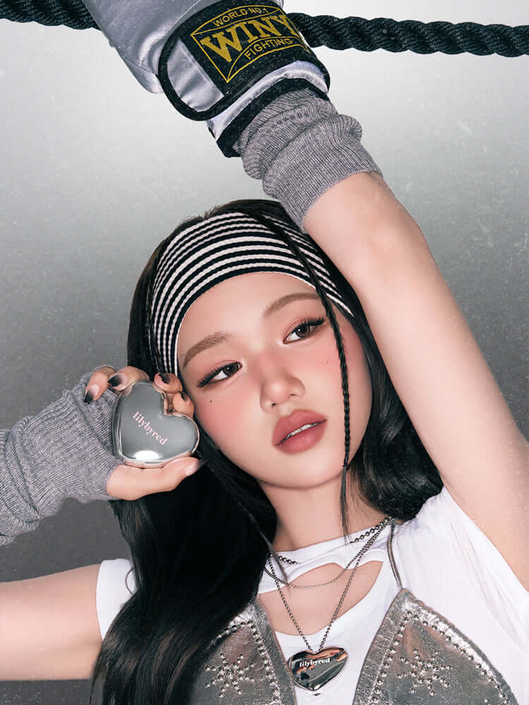 LILYBYRED Luv Beam Cheek Mousse 3.8g showcased by a model with a sporty look and trendy accessories.