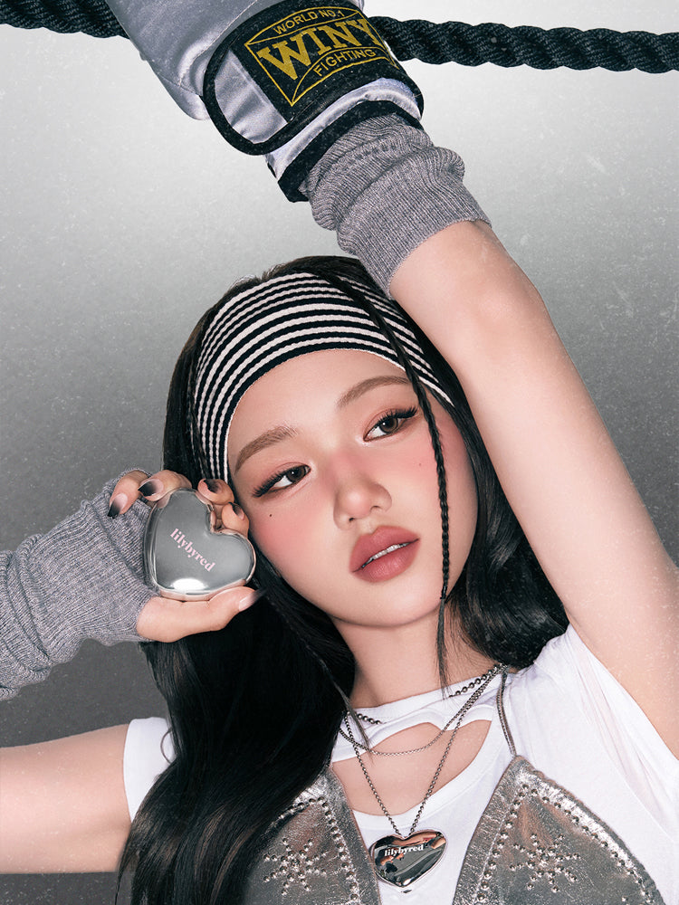LILYBYRED Luv Beam Cheek Mousse 3.8g showcased by a model with a sporty look and trendy accessories.
