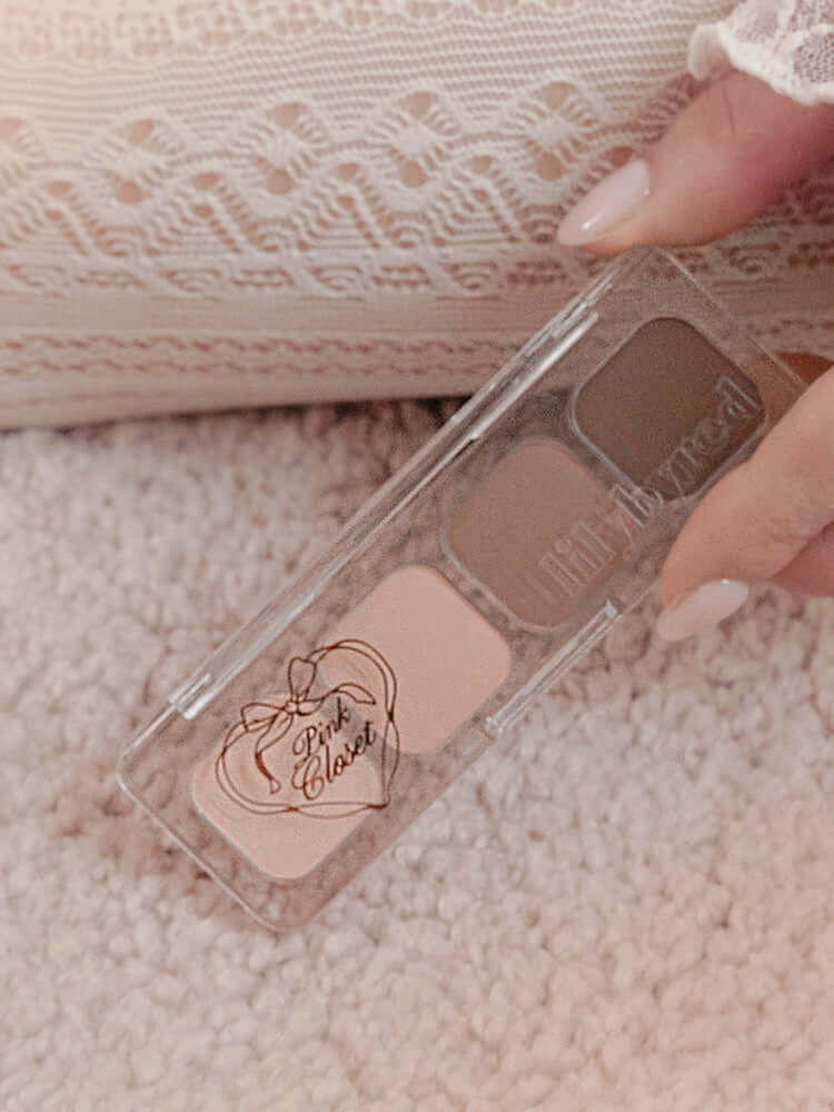 LILYBYRED [Pink Closet Edition] Mood It Palette showing soft pink and neutral shades held by a hand on a textured surface.