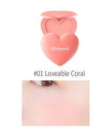 LILYBYRED Luv Beam Cheek 4.7g in Loveable Coral shade, showcasing creamy texture and vibrant color on skin.