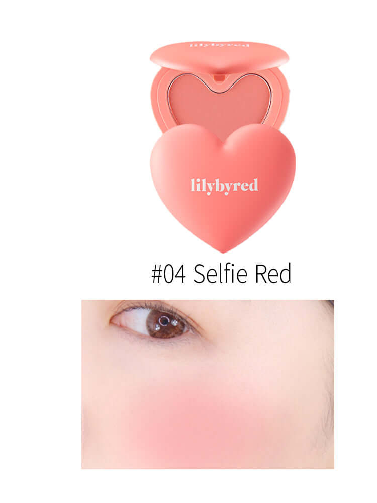 LILYBYRED Luv Beam Cheek 4.7g in heart-shaped packaging with #04 Selfie Red shade, showcasing a radiant blush on skin.