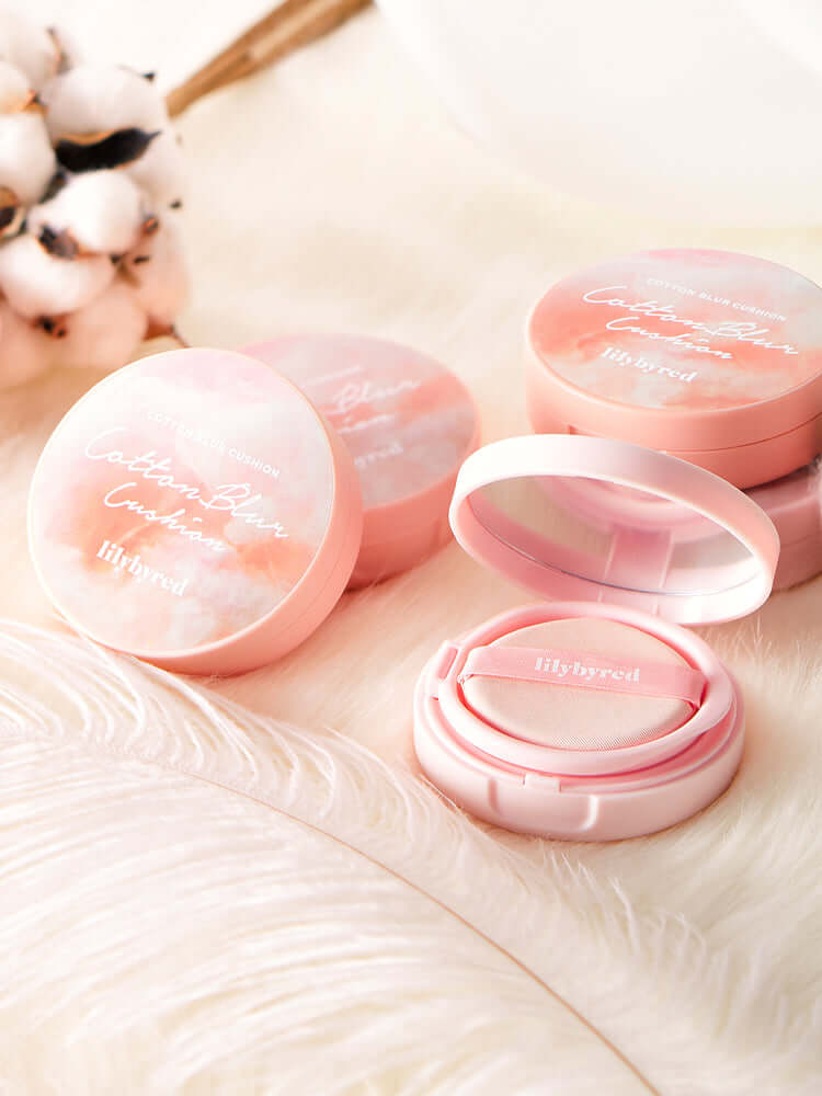 LILYBYRED Cotton Blur Cushion 15g SPF50+PA+++ products displayed on a soft background with cotton and feathers.