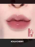 LILYBYRED Cherry Bell soft cherry-toned lips with a glossy finish and product packaging in view.