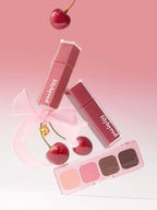LILYBYRED Cherry Bell lip products and eyeshadow palette featuring cherry tones on a pink background.