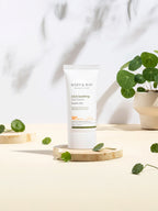 MARY&MAY CICA Soothing Sun Cream 50ml SPF50+/PA++++ displayed with green leaves on a light background.