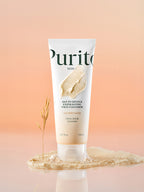 PURITO Oat In Gentle Exfoliating Face Cleanser 150ml tube with creamy texture and oat seed water on a soft background.