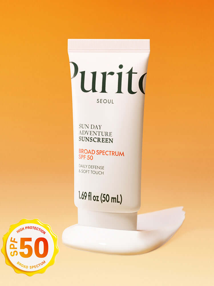 PURITO Sun Day Adventure Sunscreen 50ml tube against orange background with a dollop of sunscreen.