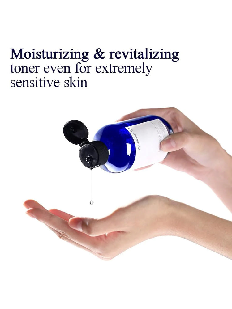 Hands holding PYUNKANG YUL Essence Toner with drops, emphasizing moisturizing and revitalizing properties for sensitive skin.