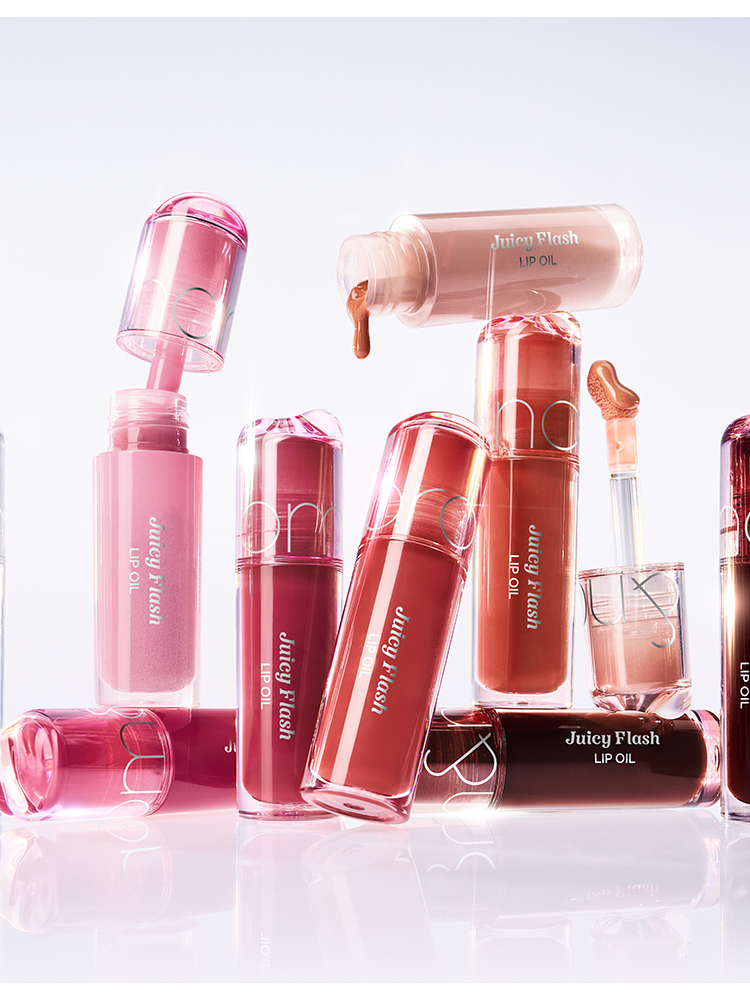 Collection of ROMAND Juicy Flash Lip Oil bottles showcasing vibrant shades and ultra-reflective gloss.