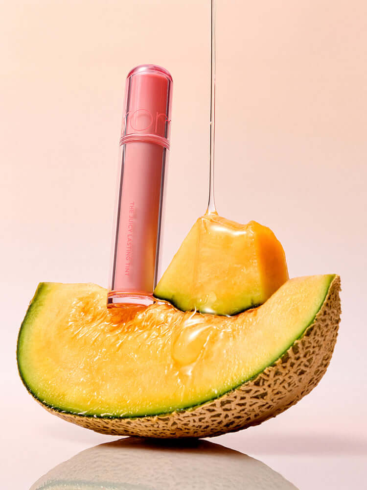 rom&nd The Juicy Lasting Tint 2.0 3.5g displayed with juicy melon slice, highlighting exotic fruit essence.