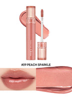 rom&nd Glasting Color Gloss Peach Sparkle in peach color with applicator and swatch, featuring plump, glossy lips.
