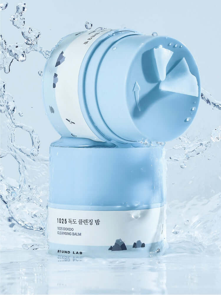 ROUND LAB 1025 Dokdo Cleansing Balm 100ml displayed with splashes of water for a refreshing cleanse.