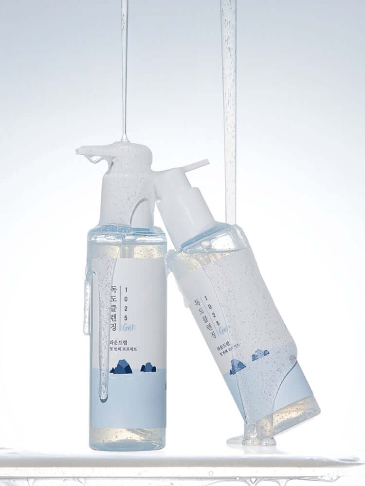 ROUND LAB 1025 Dokdo Cleansing Gel 150ml bottles with bubbles, showcasing gentle cleansing properties.