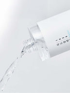 ROUND LAB 1025 Dokdo Cleansing Water 400ml pouring from the bottle, showcasing its clear, gentle formula.