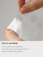 Hand removing hydrocolloid spot patch from protective film, showcasing easy-to-use design and functionality.