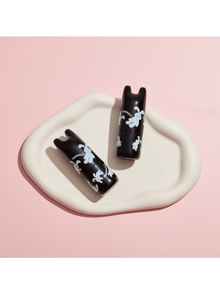 TONYMOLY Pocket Bunny Perfume Bar displayed on a cream-colored plate with a playful bunny design.