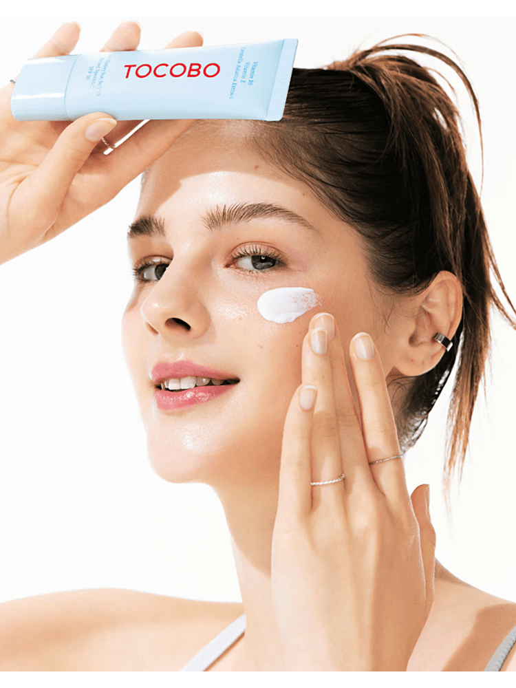 Model applying TOCOBO Bio Watery Sun Cream 50ml SPF50+/PA++++ to her face for sun protection.