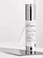 VT Reedle Shot 100 50ml on a reflective surface, showcasing its CICA pre-care skin treatment.